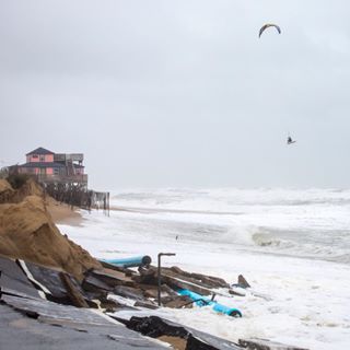  Braving the storm. Riding through the rubble, @epic.dimitri goes big in #hurricanejoaquin. @epic_kites Photo: @mattlusk 